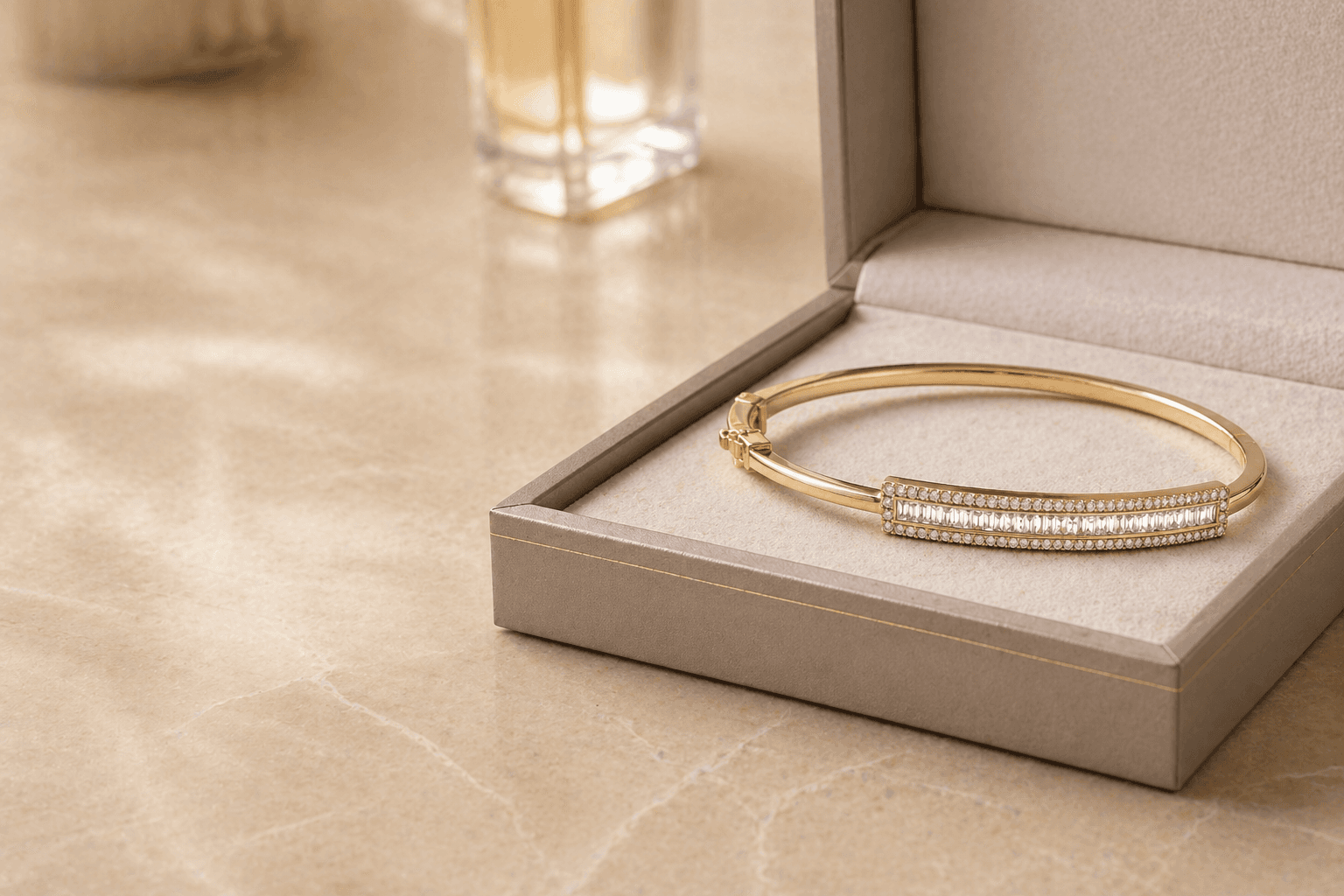Gold and diamond bangle in a presentation box on a marble surface